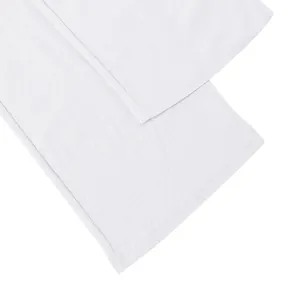 Close-up detail of white linen men's trousers hem with high-quality stitching