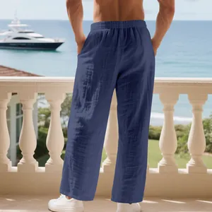 Men's loose linen pleated straight pants shown from the back in a resort setting.