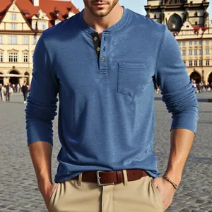 Close-up of men's casual blue long-sleeve Henley shirt in a European outdoor setting.