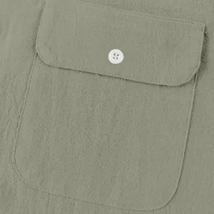 Close-up of pocket detail on sage green linen men's Henley shirt with white button