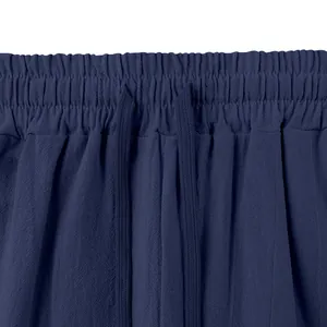 Detail of navy blue men's linen trousers featuring an elastic waistband and drawstring.