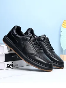 Detail shot of black top-grain leather men's casual shoes with soft non-slip soles.