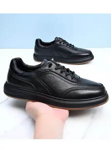 Close-up of black genuine leather men's sneakers with pebbled texture