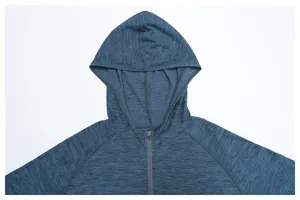 Detail of a blue quick-drying hooded running jacket with a textured marl finish.