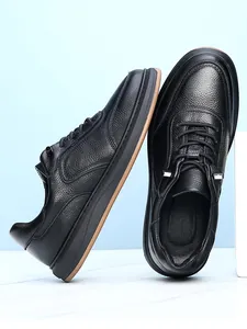 Detail shot of the black pebble grain leather texture on men's casual leather shoes
