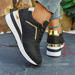 Side view detail of black wedge sneakers with gold accents showing 7cm platform heel