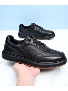Side view detail of men's black leather casual shoes with breathable holes and soft sole.