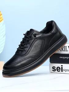 Detailed view of premium black genuine leather men's casual shoes with non-slip soft sole.