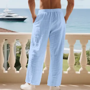 Back view of men's light blue loose linen pants showing wrinkled texture and casual fit