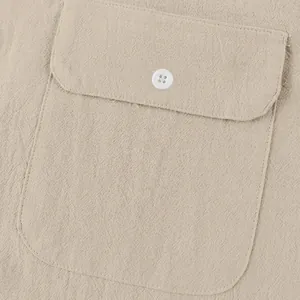 Detailed close-up of natural linen fabric texture and pocket on a men's Henley shirt
