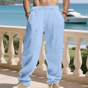 Detail view of men's loose light blue linen trousers with unique pleated knee design.