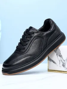 Detailed side view of premium black grain leather men's casual sneakers with soft sole