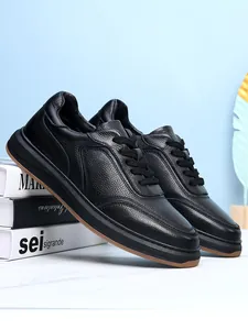 Side detail of black first-layer cowhide men's casual shoes on white props