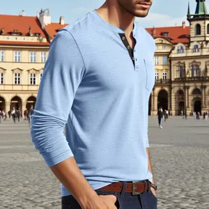 Men's casual long sleeve blue Henley t-shirt shown in a scenic outdoor urban setting