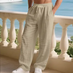 Macro view of khaki linen men's trousers featuring drawstring waist and pleated details