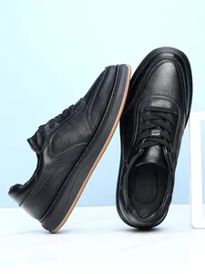Detail view of men's black pebble grain leather sneakers showing premium texture