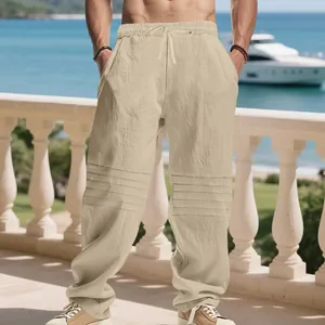 Men's loose linen trousers featuring relaxed fit and pleated knee details for resort style