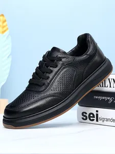 Close-up of black genuine leather men's casual shoe with breathable perforation