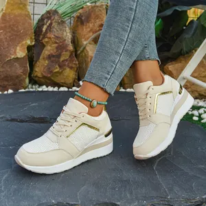 Stylish beige platform wedge sneakers with gold accents and lace-up design for women