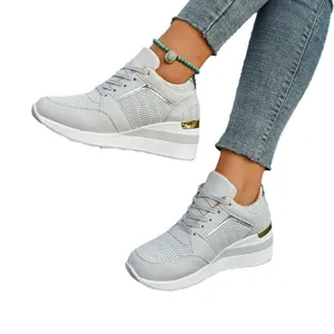 Stylish women's grey wedge platform sneakers with lace-up design and breathable mesh material