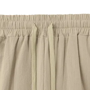 Close-up detail of the elastic drawstring waistband on men's linen loose fit trousers