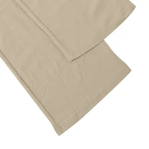 Detailed view of the hem stitching and linen fabric texture on men's wide-leg pants