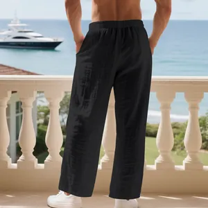 Back view of men's loose black linen pants with pleated texture and elastic waist