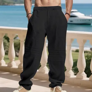Close-up of black men's linen trousers featuring stylish pleated knee design and drawstring.