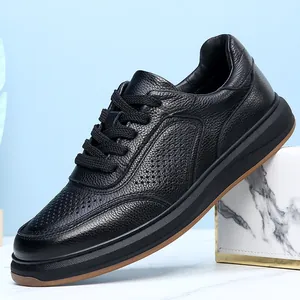 Detailed macro view of breathable genuine leather texture on black casual shoes for men