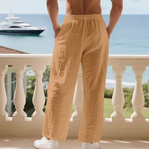 Detailed back view of men's loose linen trousers in tan with a pleated texture.