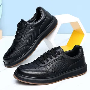 Close-up of men's black top-grain cowhide leather casual sneakers with textured finish