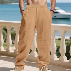 Detailed view of men's loose linen trousers featuring unique pleated knee accents