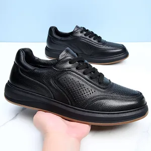 Detailed macro view of black cowhide leather casual shoes with breathable hole detailing