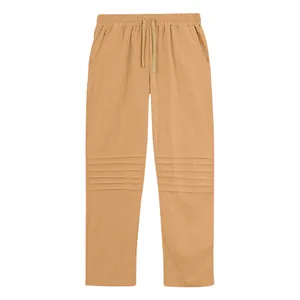 Detailed view of men's loose linen pants with unique horizontal pleated design on legs