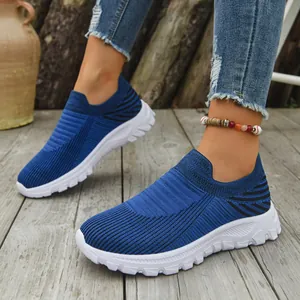 Detailed view of the breathable blue knit upper and white sole of leisure slip-on sneakers
