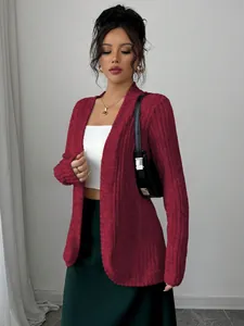 Detailansicht eines roten Damen-Cardigans mit weißem Schlauchtop und grünem Rock