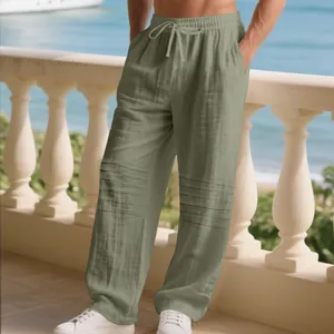 Close-up view of men's loose linen straight leg pants in sage green with knee pleats