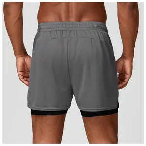Vista trasera de los pantalones cortos deportivos 2 en 1 grises para hombre de malla.