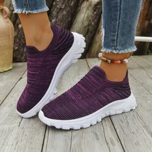 Macro detail showing the breathable purple fly-knit texture of casual slip-on sneakers