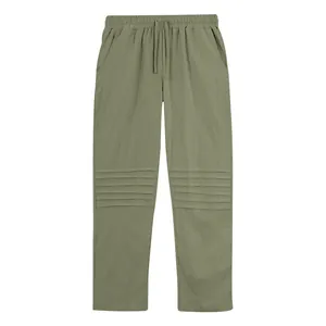 Detail view of men's olive green linen pants featuring unique knee pleats.