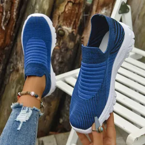 Detailed macro view of blue breathable knit fly-woven slip-on sneakers for casual wear