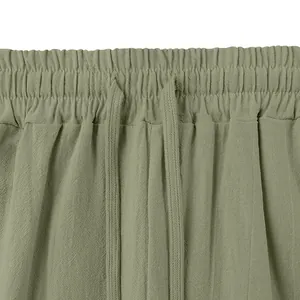 Close-up detail of men's linen pants featuring elastic waistband and drawstring