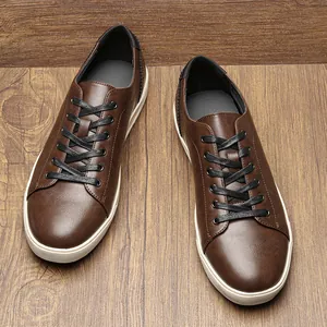 Top-down view of men's retro brown faux leather casual sneakers on a wooden texture background