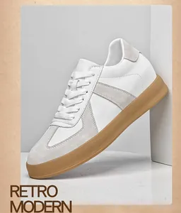 Detailweergave van witte retro GAT-sneakers voor heren met gomzool.
