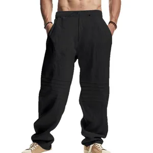 Men's loose black linen pants featuring pleated knee details and adjustable drawstring