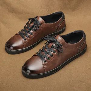 Detail view of men's vintage brown burnished casual lace-up shoes on tan fabric background