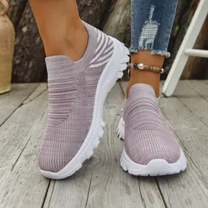 Lavender breathable fly-knit slip-on sneakers worn on a natural wooden deck scene