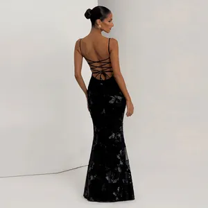 Detail view of a black backless mermaid dress with criss-cross straps and shimmering patterns