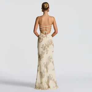 Detailed view of backless maxi dress with delicate floral embroidery and lace-up straps