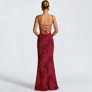 Detail view of the backless lace-up design on this elegant burgundy floral evening dress.